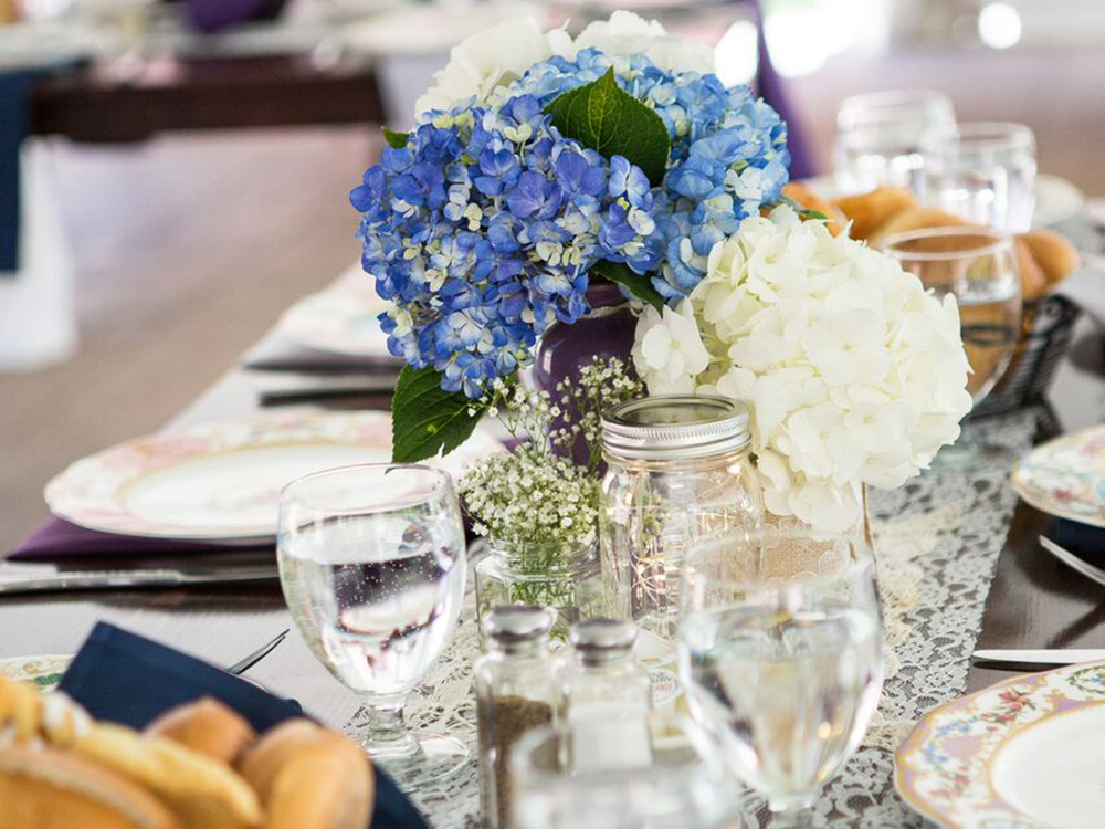 Flowers and place setting - Robin’s Nest Mount Holly offers catering services and is a special event venue
